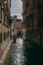 Gondolas on a narrow canal leading to Grand Canal in Venice, Italy.