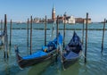 Gondolas near Saint Mark square San Marco and San Giorgio di Maggiore church in the background, in Venice, Italy Royalty Free Stock Photo