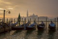 Gondolas by Saint Mark square during sunrise