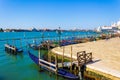 Gondolas station blue lagoon Venice waterfront Italy Royalty Free Stock Photo