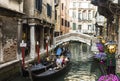 Gondolas with tourists sailing along a canal in Venice,