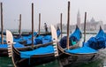 Gondolas in Venice. The gondolas are moored at the mooring posts. Venice, Italy. Royalty Free Stock Photo