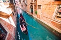 Gondolier carries tourists on gondola Grand Canal of Venice, Italy