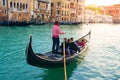 Gondolier carries tourists on gondola Grand Canal of Venice, Italy Royalty Free Stock Photo