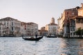 Gondolier is driving a gondola with people  on the Grand Canal of Venice, Italy Royalty Free Stock Photo