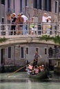 Gondolier, gondola and tourists in Venice