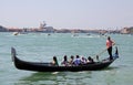 Gondolier, gondola and tourists in Venice