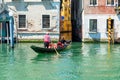 Gondolier Navigating a Quiet Venetian Canal in Sunny Italy Royalty Free Stock Photo