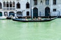 Gondolier Navigating with Tourists on Venetian Canal Royalty Free Stock Photo