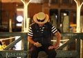 Gondolier resting at night in Venice, Italy