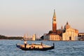 Gondolier rides gondola on Grand canal, Venice