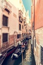 Gondolier rowing gondola on canal in Venice, Italy. Royalty Free Stock Photo