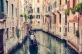 Gondolier rowing gondola on canal in Venice, Italy. Royalty Free Stock Photo