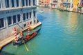 Gondolier on sailing gondola traditional boat in water of Grand Canal waterway in Venice Royalty Free Stock Photo