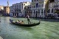 A Gondolier taking passengers by the Rialto Bridge on the beautiful city of Venice, Italy