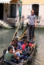 Gondolier and tourists in a gondola