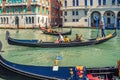 Gondolier and tourists on gondola traditional boat sailing on water of Grand Canal in Venice