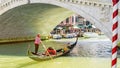 Gondolier under the Rialto Bridge of Venice, Italy Royalty Free Stock Photo