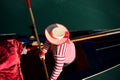 gondolier in Venice Italy with typical Venetian clothes and large straw hat while rowing on the Grand Canal Royalty Free Stock Photo