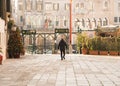 Gondolier walking towards gondola station in Venice, Italy