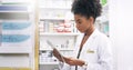 Gone are the days of piles of files. an attractive young pharmacist looking at a digital tablet in a chemist. Royalty Free Stock Photo