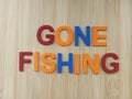 Gone fishing sign on a wood background Royalty Free Stock Photo