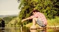 Gone Fishing. successful fisherman in lake water. hipster fishing with spoon-bait. big game fishing. relax on nature Royalty Free Stock Photo