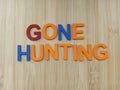 Gone hunting sign on a wood background Royalty Free Stock Photo