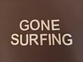 Gone surfing sign written on a brown background Royalty Free Stock Photo