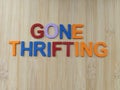 Gone thrifting sign on a wood background