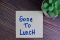 Gone To Lunch write on sticky notes isolated on Wooden Table