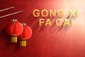 Gong Xi Fa Cai text and Chinese lanterns with red wall background Royalty Free Stock Photo