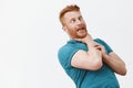 It is gonna chuckle me. Portrait of funny carefree and playful redhead guy with bristle, bending backwards while holding