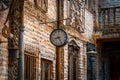GONZALEZ CATAN, ARGENTINA, SEPTEMBER 28, 2019: Very old watch hanging from a brick wall of abandoned building in the amazing Royalty Free Stock Photo