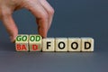 Good or bad food symbol. Doctor turns cubes and changes words `bad food` to `good food`. Beautiful grey table, grey background Royalty Free Stock Photo