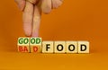 Good or bad food symbol. Doctor turns cubes and changes words `bad food` to `good food`. Beautiful orange table, orange backgr Royalty Free Stock Photo