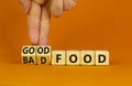 Good or bad food symbol. Doctor turns cubes and changes words `bad food` to `good food`. Beautiful orange table, orange backgr Royalty Free Stock Photo