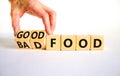 Good or bad food symbol. Doctor turns cubes and changes words `bad food` to `good food`. Beautiful white table, white backgrou Royalty Free Stock Photo