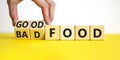 Good or bad food symbol. Doctor turns cubes and changes words `bad food` to `good food`. Beautiful yellow table, white backgro Royalty Free Stock Photo