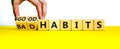 Good or bad habits symbol. Businessman turns wooden cubes and changes words `bad habits` to `good habits`. Beautiful yellow ta Royalty Free Stock Photo
