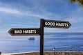 Good or bad habits symbol. Concept word Good habits Bad habits on beautiful signpost with two arrows. Beautiful blue sea sky with Royalty Free Stock Photo