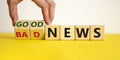 Good or bad news concept. Hand flips cubes and changes the words `bad news` to `good news`. Beautiful yellow table, white Royalty Free Stock Photo