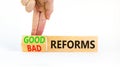 Good or bad reforms symbol. Concept words Good reforms Bad reforms on beautiful wooden blocks. Beautiful white table white