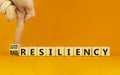 Good or bad resiliency symbol. Businessman turns a wooden cube, changes words bad resiliency to good resiliency. Beautiful orange