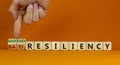 Good or bad resiliency symbol. Businessman turns wooden cubes, changes words bad resiliency to good resiliency. Beautiful orange