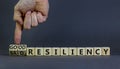 Good or bad resiliency symbol. Businessman turns wooden cubes, changes words bad resiliency to good resiliency. Beautiful grey