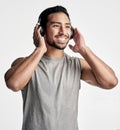 A good beat can help you keep pace. Studio shot of a sporty young man wearing headphones against a white background. Royalty Free Stock Photo
