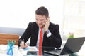 Good business talk. Handsome young man in formalwear talking on the phone and smiling while sitting