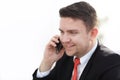 Good business talk. Handsome young man in formalwear talking on the phone and smiling while sitting Royalty Free Stock Photo