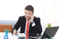 Good business talk. Handsome young man in formalwear talking on the phone and smiling while sitting